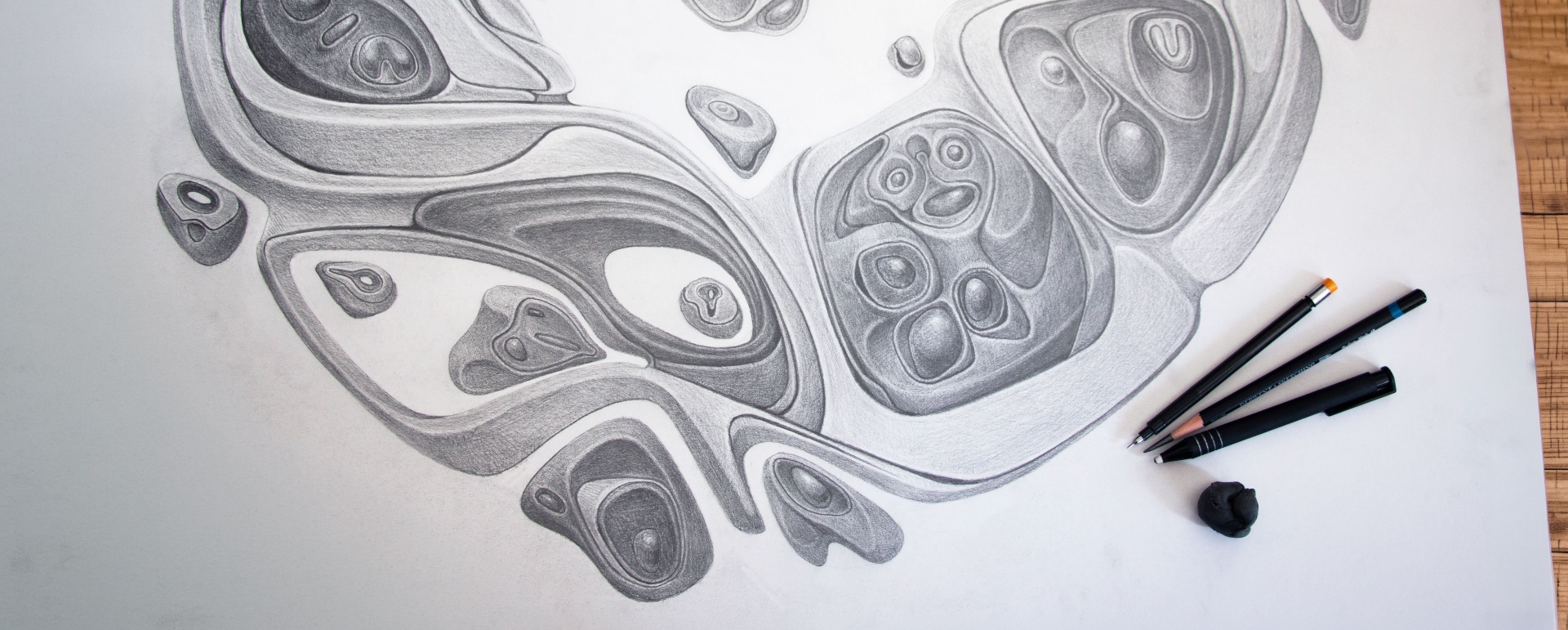 A horizontal frieze of four biomorphic reliefs in a deep black frame